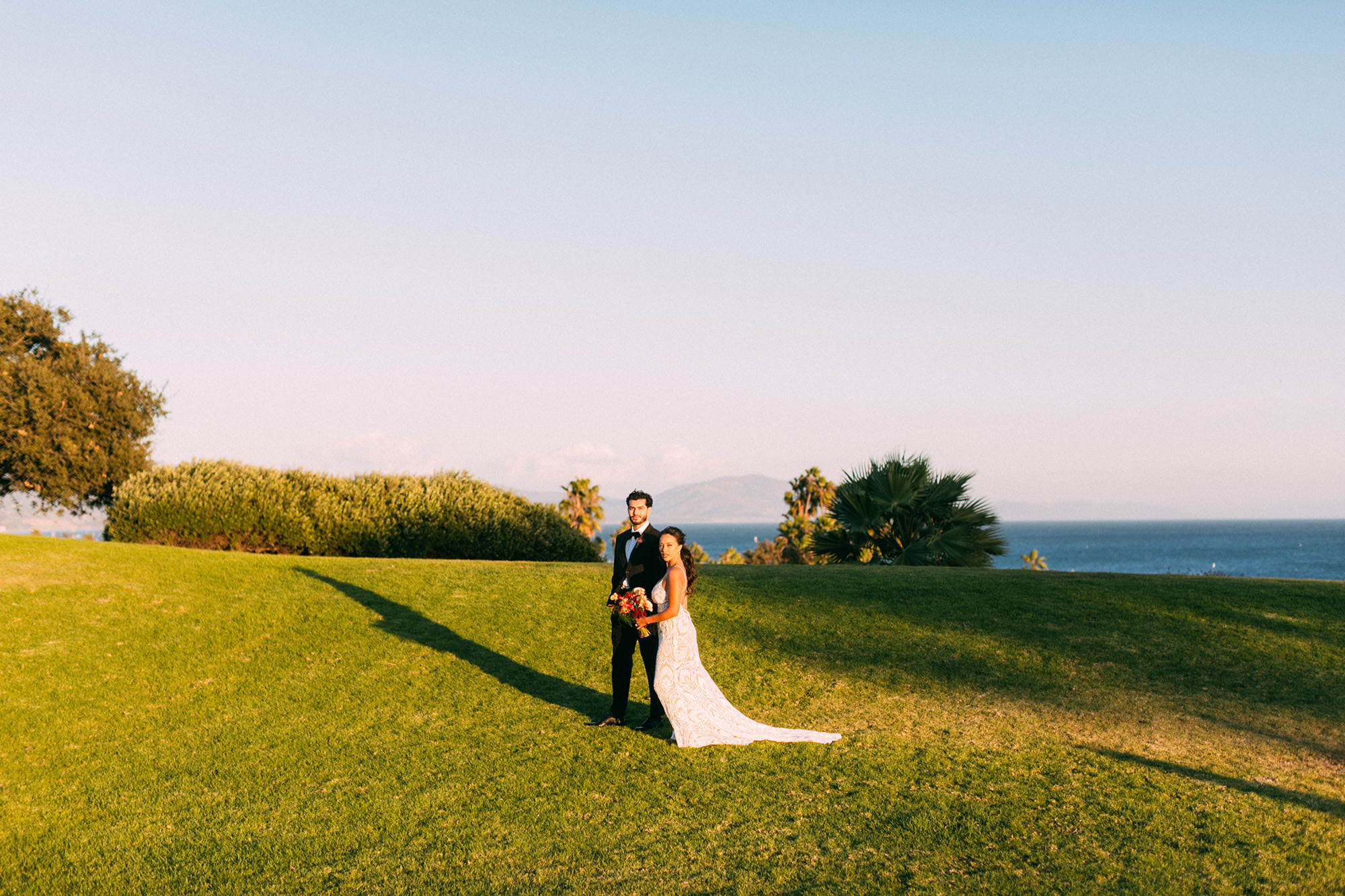 Wedding couple walking across Great Meadow